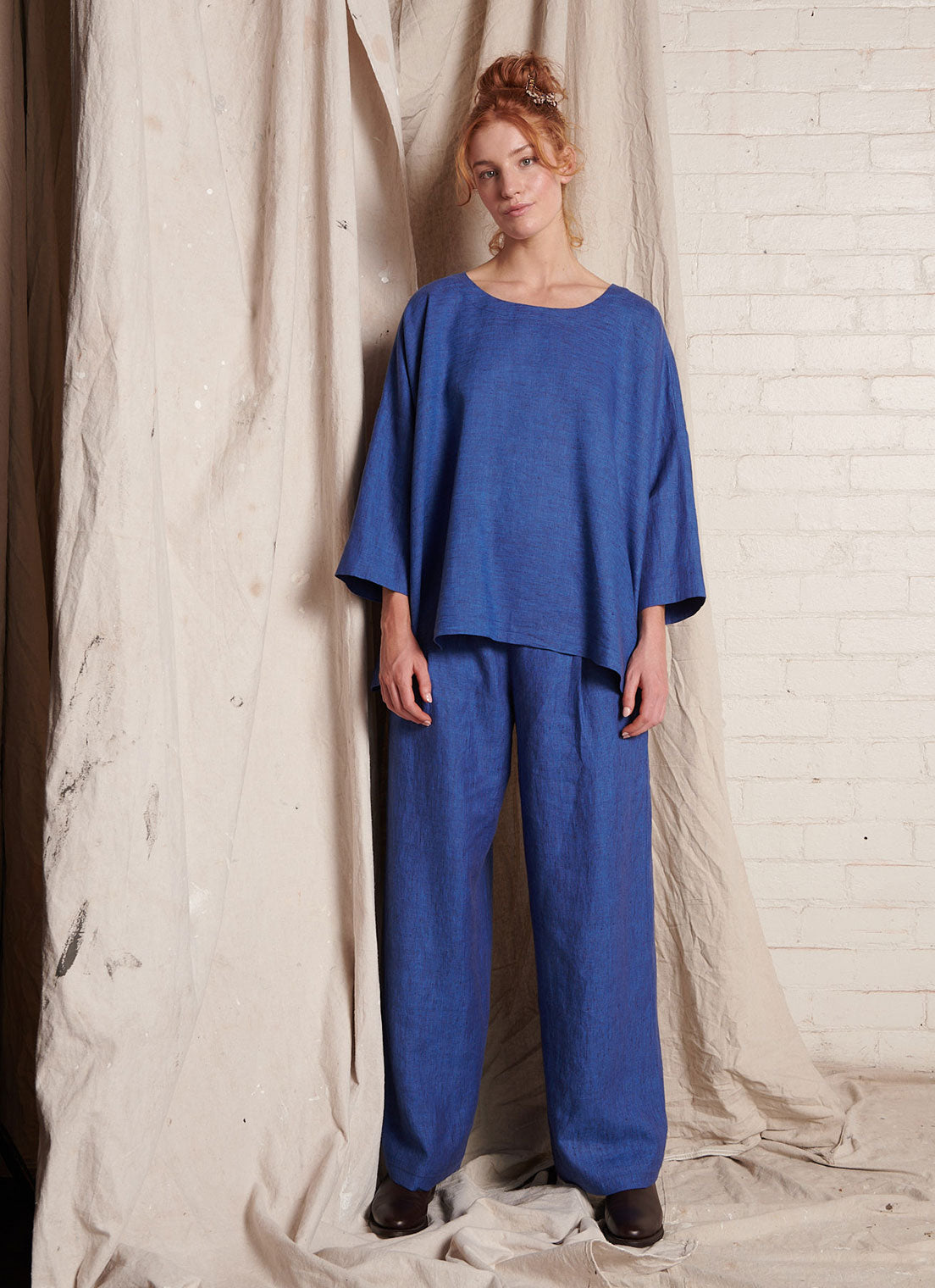 A blue, easy fit top with round neckline, long sleeves and embroidered detail at the back made from European pure linen