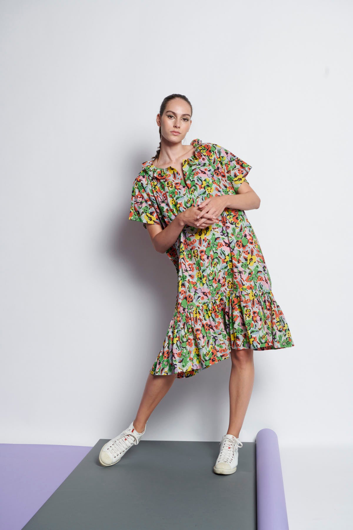 A floral, easy-fit, knee-length summer dress made of cotton and has ruffled neckline and gathers at hem