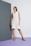 A white A-line cotton sleeveless dress that has a stripe fringe detail