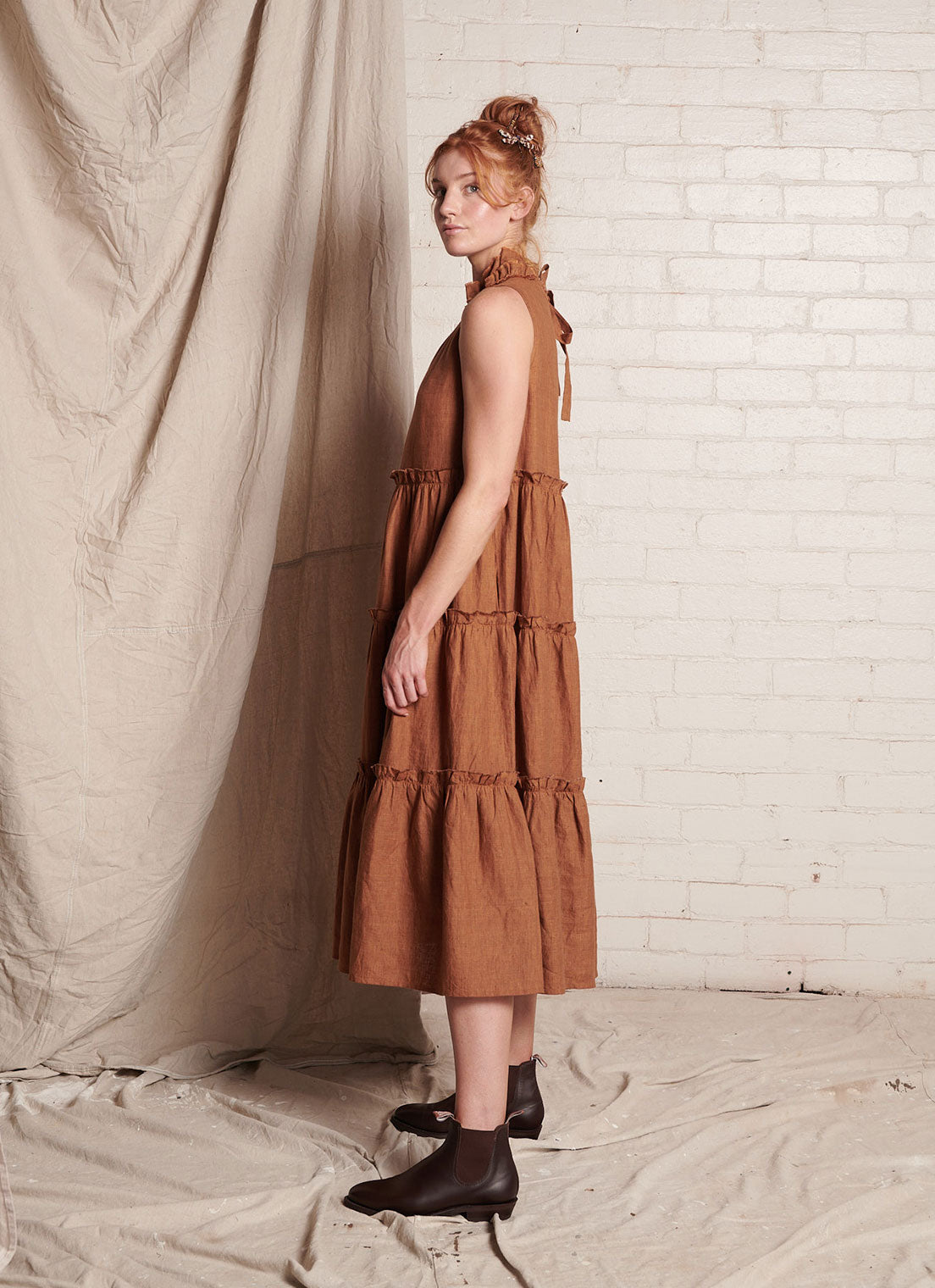 A bronze, sleeveless, pure European linen, tiered dress with ruffled collar and detailing