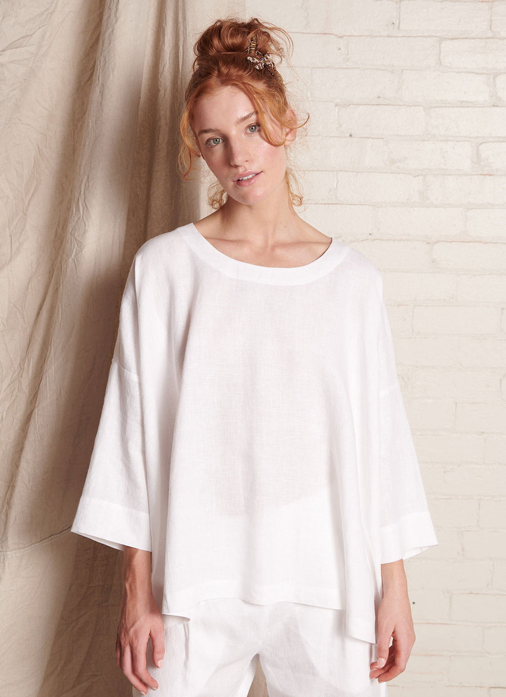 A white, easy fit top with round neckline, long sleeves and embroidered detail at the back made from European pure linen