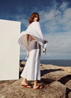 A cropped pant with drawstring waistband and pockets made from yarn dye stripe washed linen in white with indigo stripe