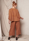 A bronze, easy fit top with round neckline, long sleeves and embroidered detail at the back made from European pure linen