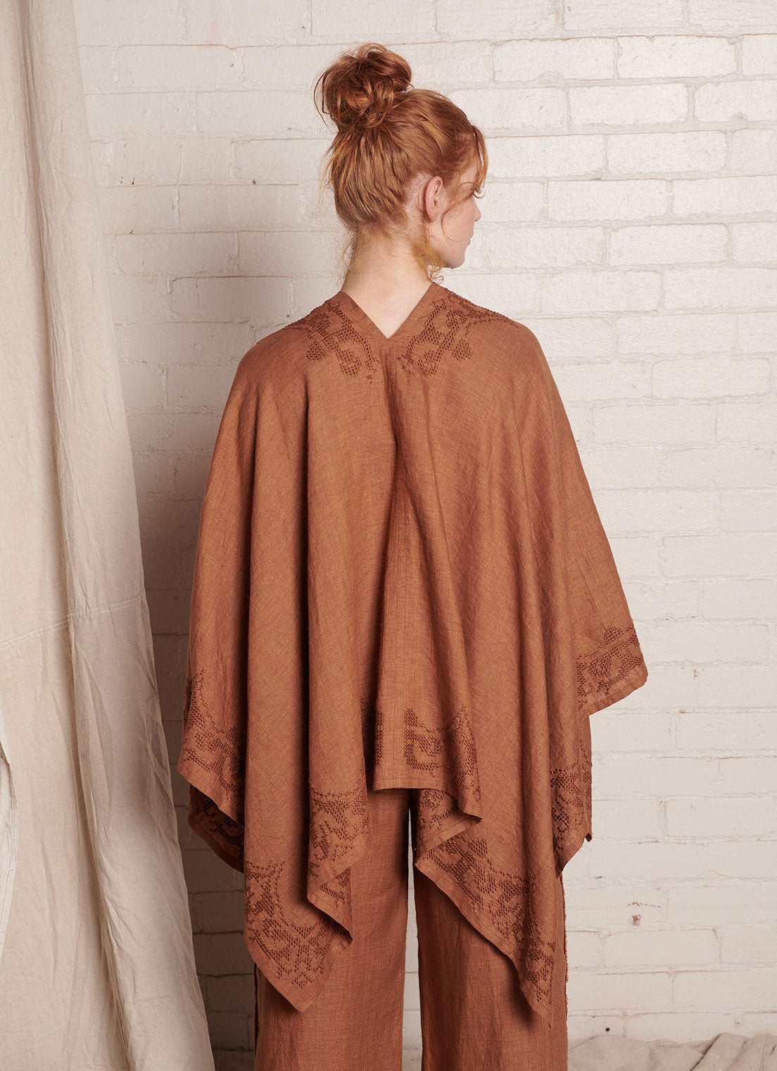A one size, easy fit, bronze embroidered cape shawl made from European pure linen