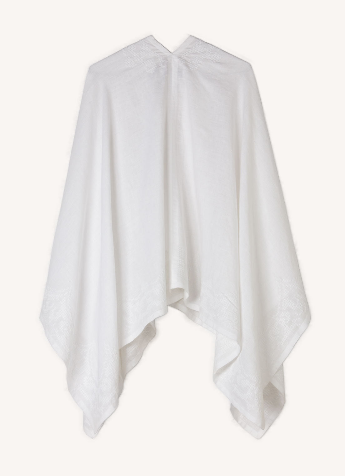 A one size, easy fit, white embroidered cape shawl made from European pure linen