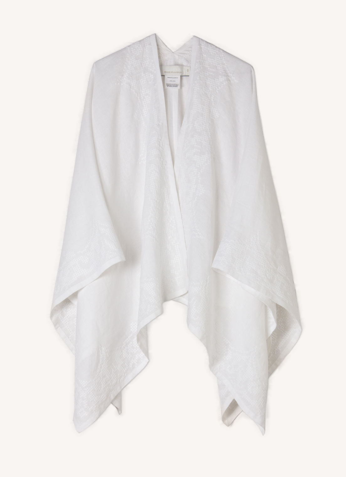 A one size, easy fit, white embroidered cape shawl made from European pure linen