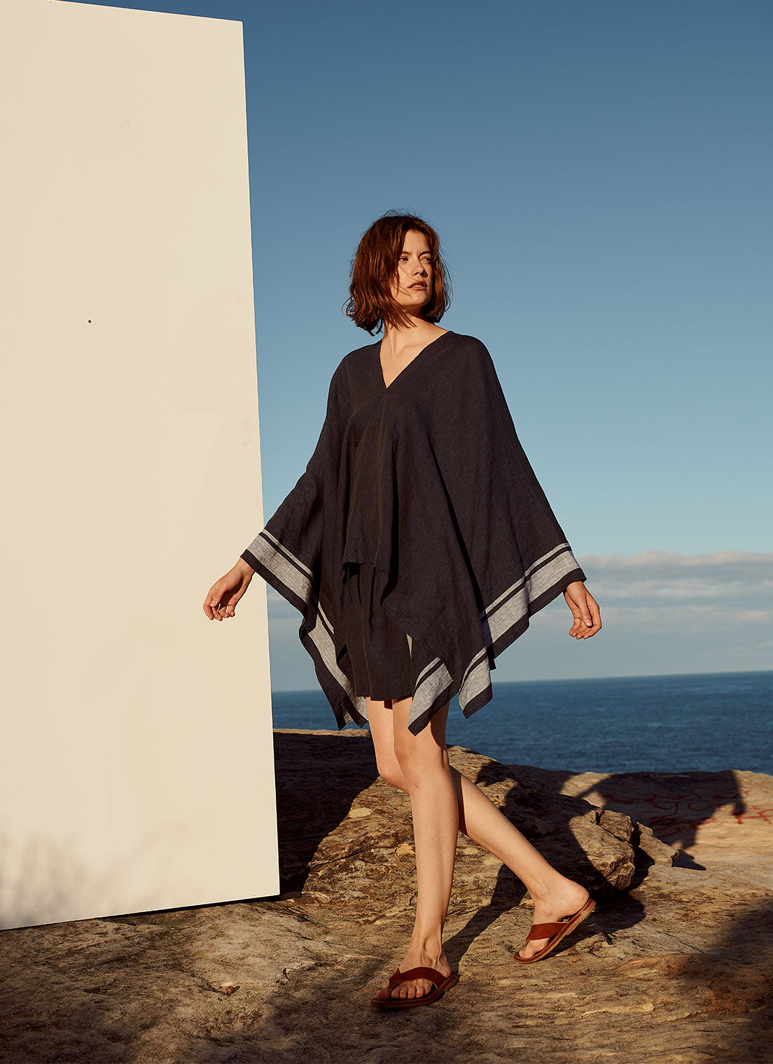 An easy fit, square cut, v-neck poncho with long sleeves made from yarn dye stripe washed linen in ink with pale blue stripe