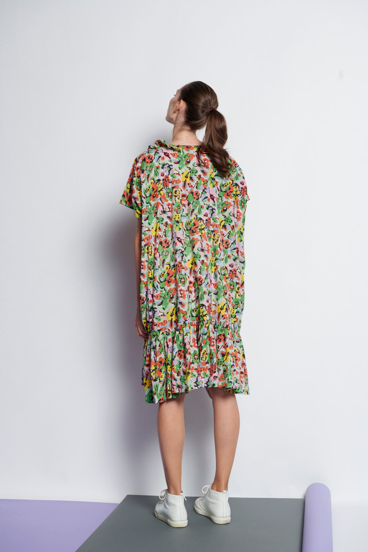 A floral, easy-fit, knee-length summer dress made of cotton and has ruffled neckline and gathers at hem