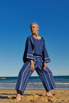 An indigo stripe linen, cropped pants with a wide, elasticised waistband, belt of the same fabric and pockets 