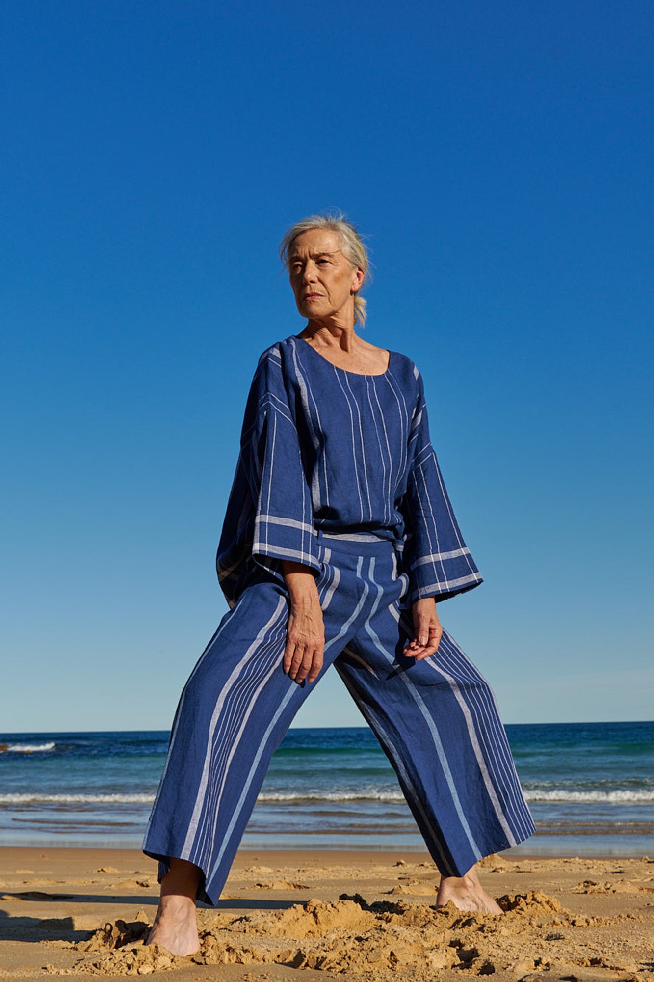 An indigo stripe linen, cropped pants with a wide, elasticised waistband, belt of the same fabric and pockets 