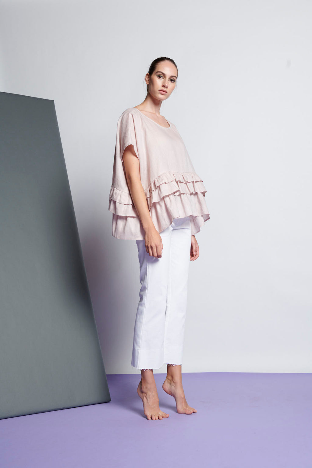 An easy-fit, tiered ruffle linen top with round neckline and short sleeves in very pale pink