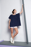 A navy blue easy fit, square cut top made from cotton and linen with round neckline, short sleeves, and striped fringe fabric 