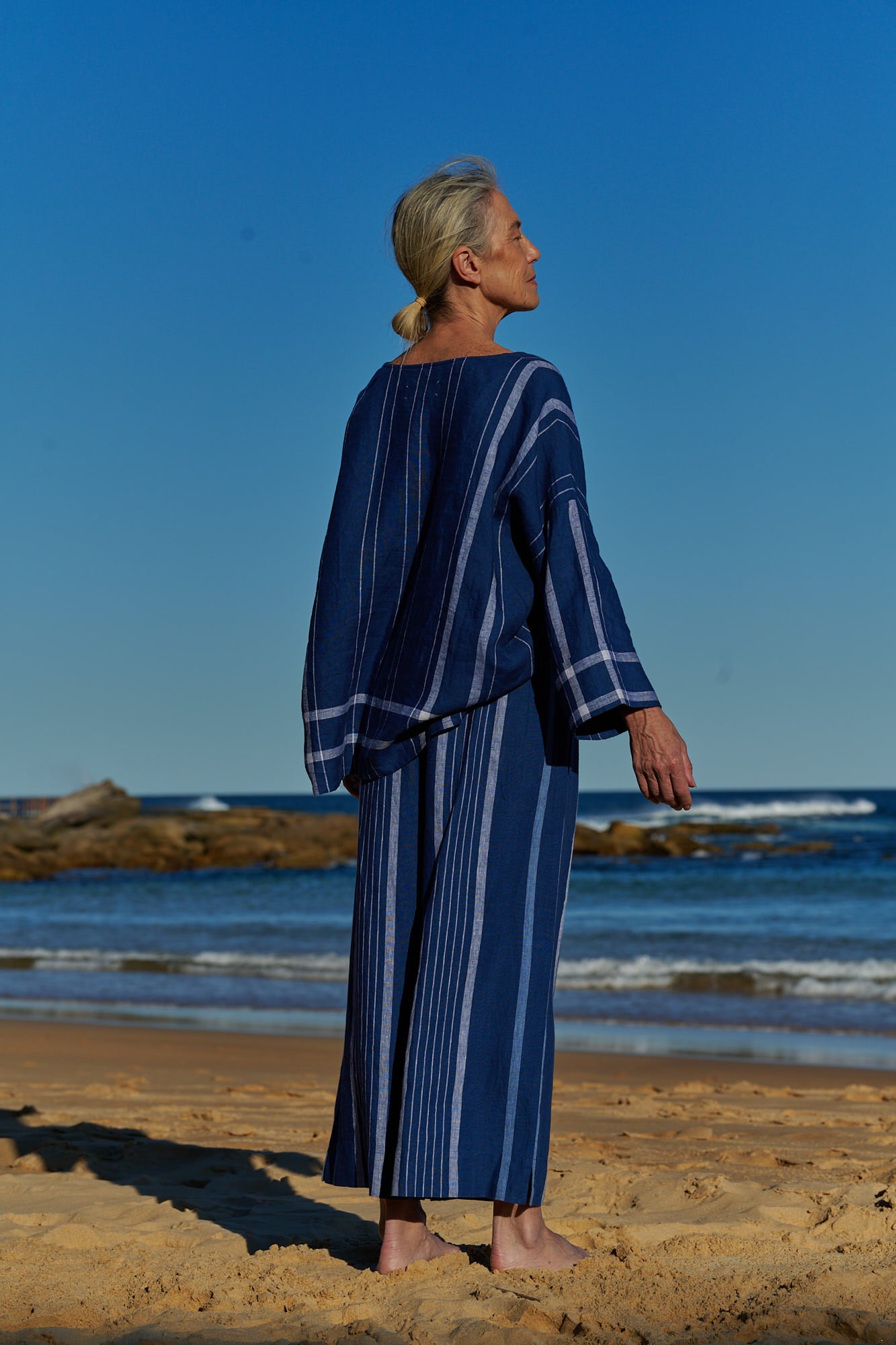 An easy fit, one size, double plaid indigo linen top with round neckline and long sleeves