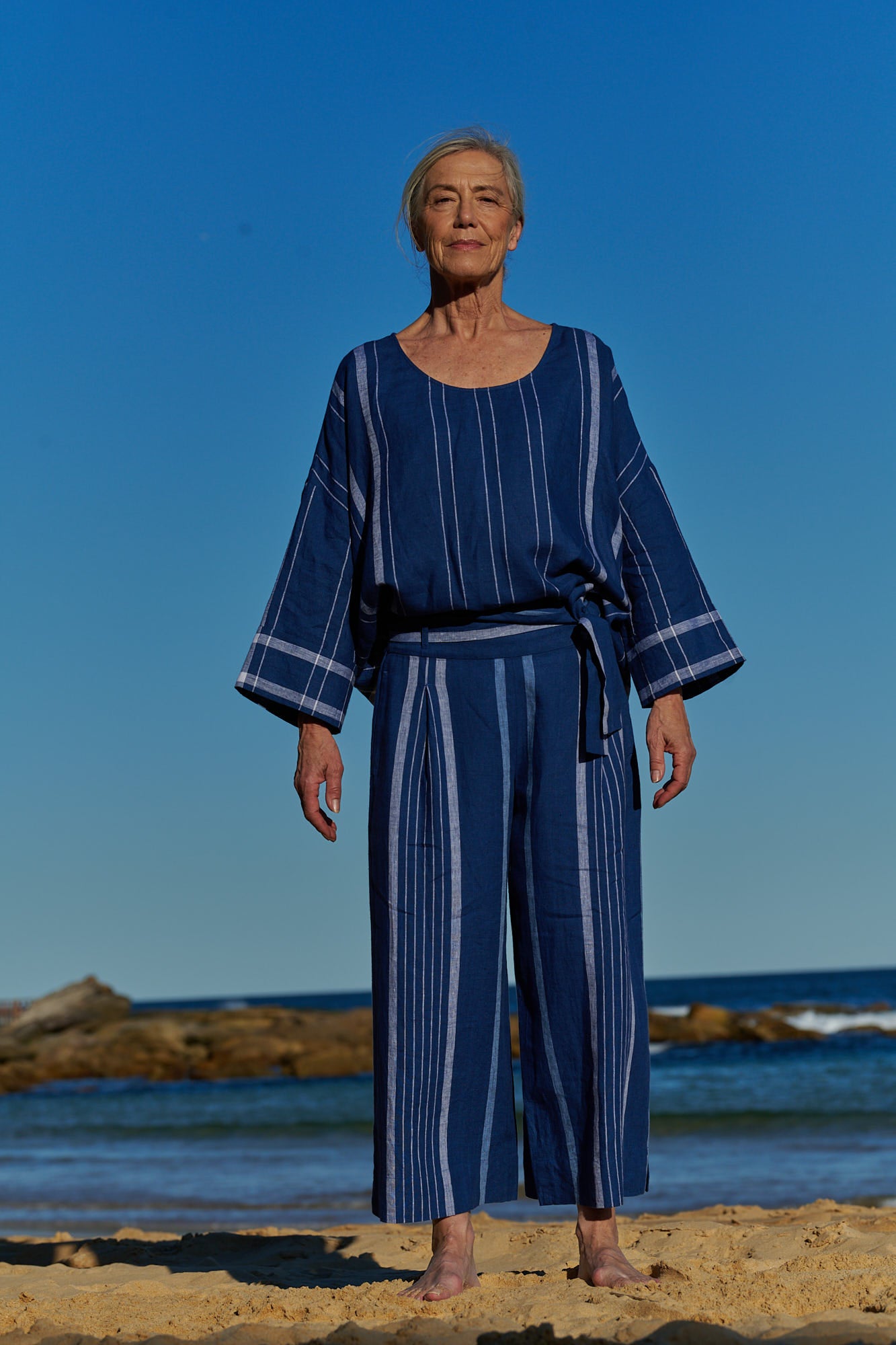 An easy fit, one size, double plaid indigo linen top with round neckline and long sleeves