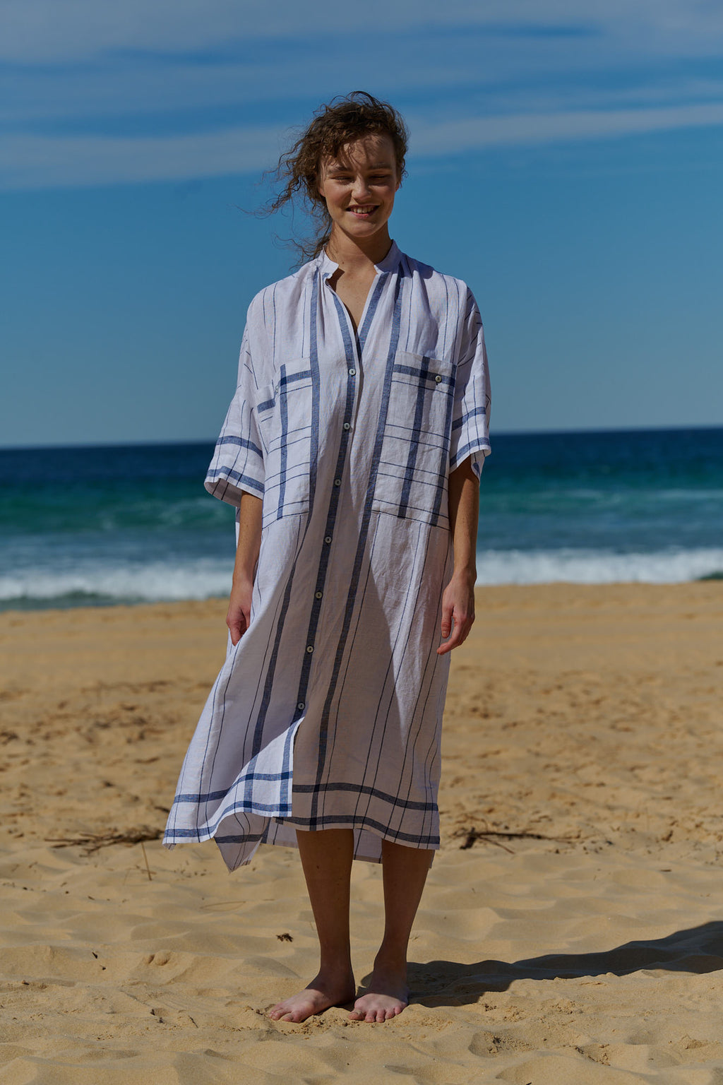 A one size, easy fit, midi-length plaid linen white shirtdress with short sleeves