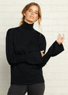 An Australian pure merino wool knit in black with a turtleneck and long bell sleeves