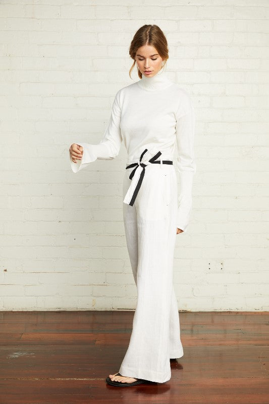 An Australian pure merino wool knit in ivory with a turtleneck and long bell sleeves