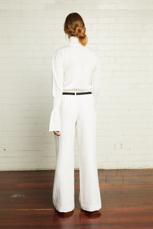 An Australian pure merino wool knit in ivory with a turtleneck and long bell sleeves