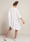 A white, easy fit, knee-length, square-cut dress with open neckline, 3/4 sleeves, and gathered detailing made from yarn dye washed linen