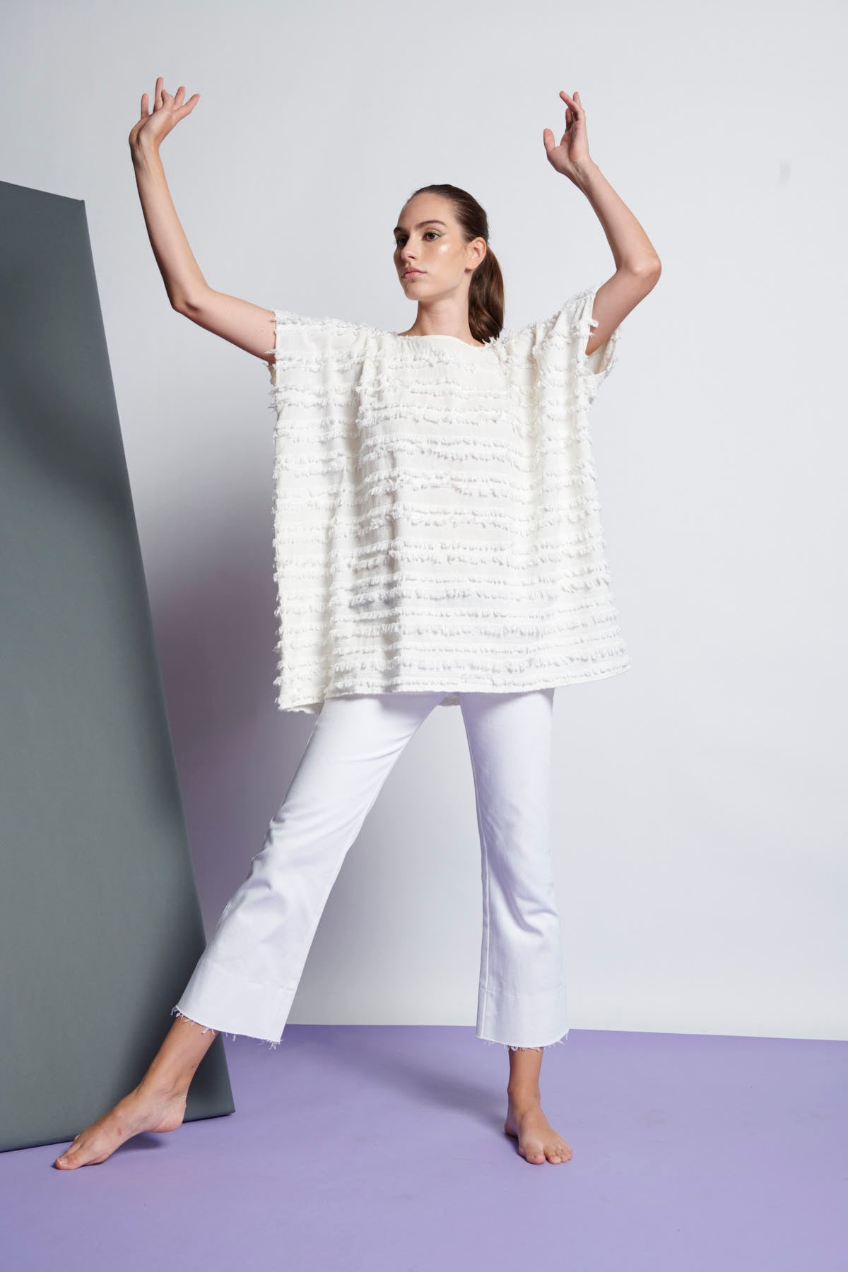 A white easy fit, square cut top made from cotton and linen with round neckline, short sleeves, and striped fringe fabric