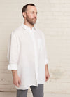 A white, relaxed fit, unisex shirt with collar, sleeve cuff and centre front button fastening made from yarn dye washed linen