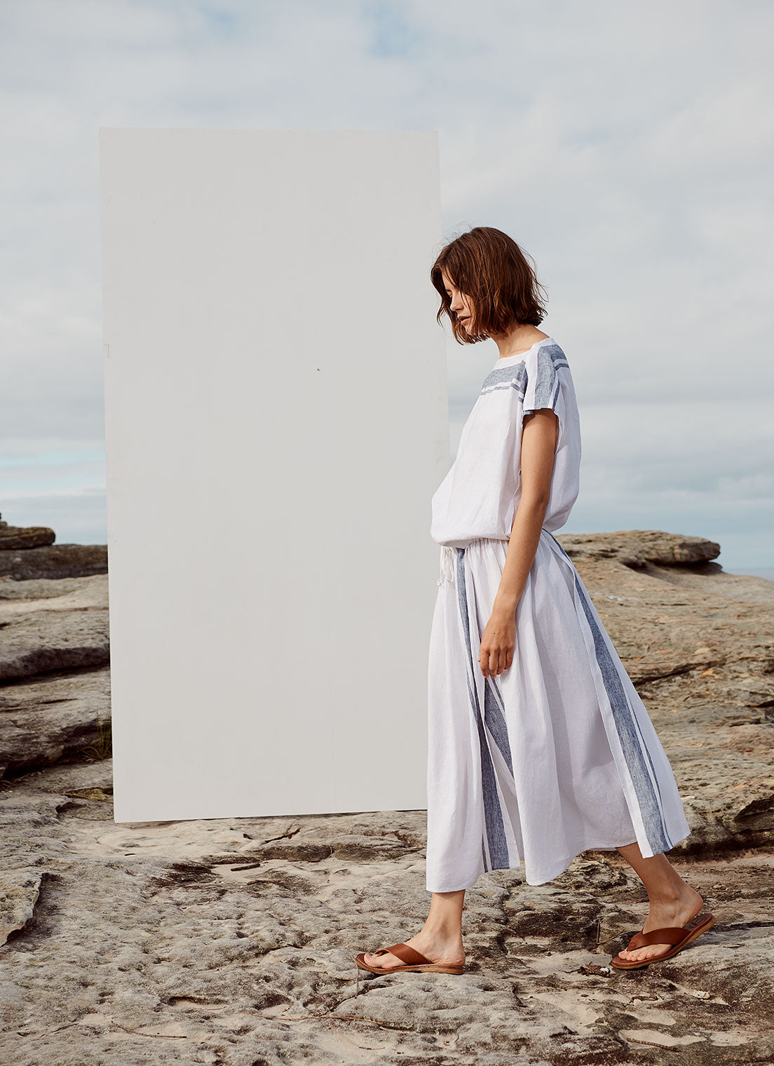 A midi-length skirt with elastic waist made from yarn dye stripe washed linen in white with indigo stripe