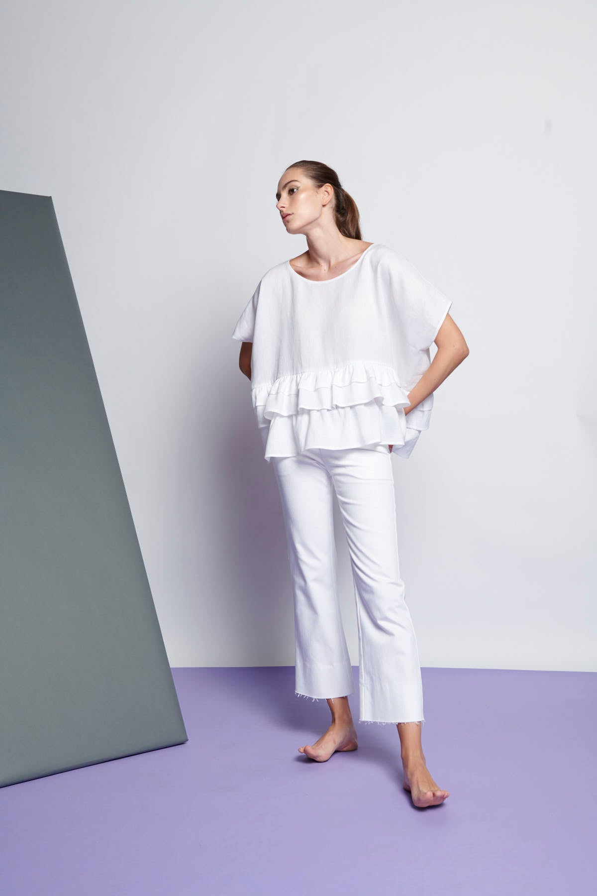An easy-fit, tiered ruffle linen top with round neckline and short sleeves in white
