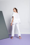 An easy-fit, tiered ruffle linen top with round neckline and short sleeves in white