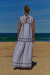 A white plaid V-neck, sleeveless, tiered maxi linen dress with pleat detail at neckline