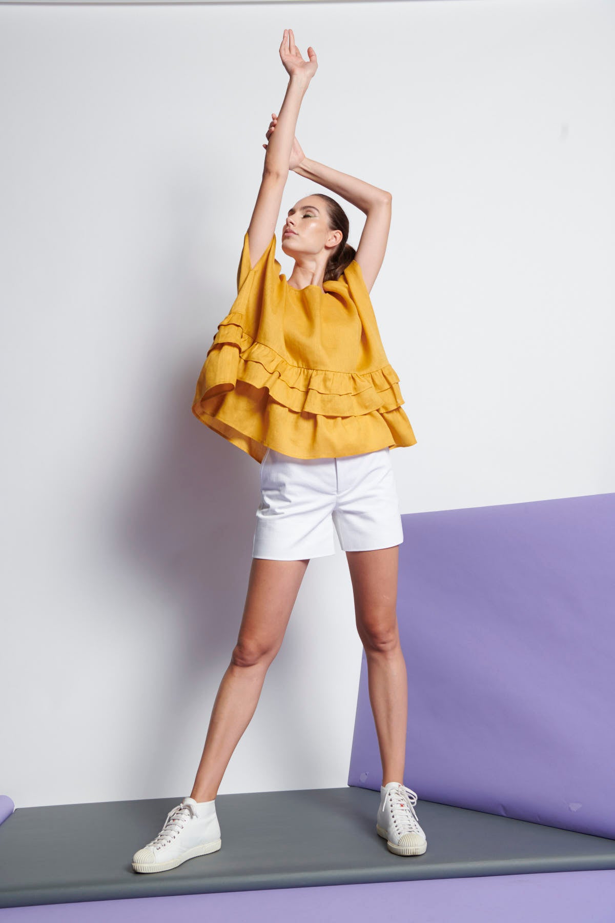 An easy-fit, tiered ruffle linen top with round neckline and short sleeves in yellow