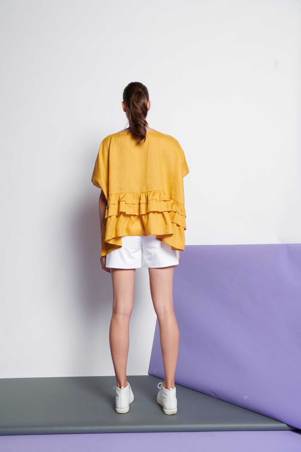 An easy-fit, tiered ruffle linen top with round neckline and short sleeves in yellow